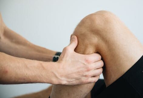 Detailed image of a physiotherapy session focusing on knee massage treatment.